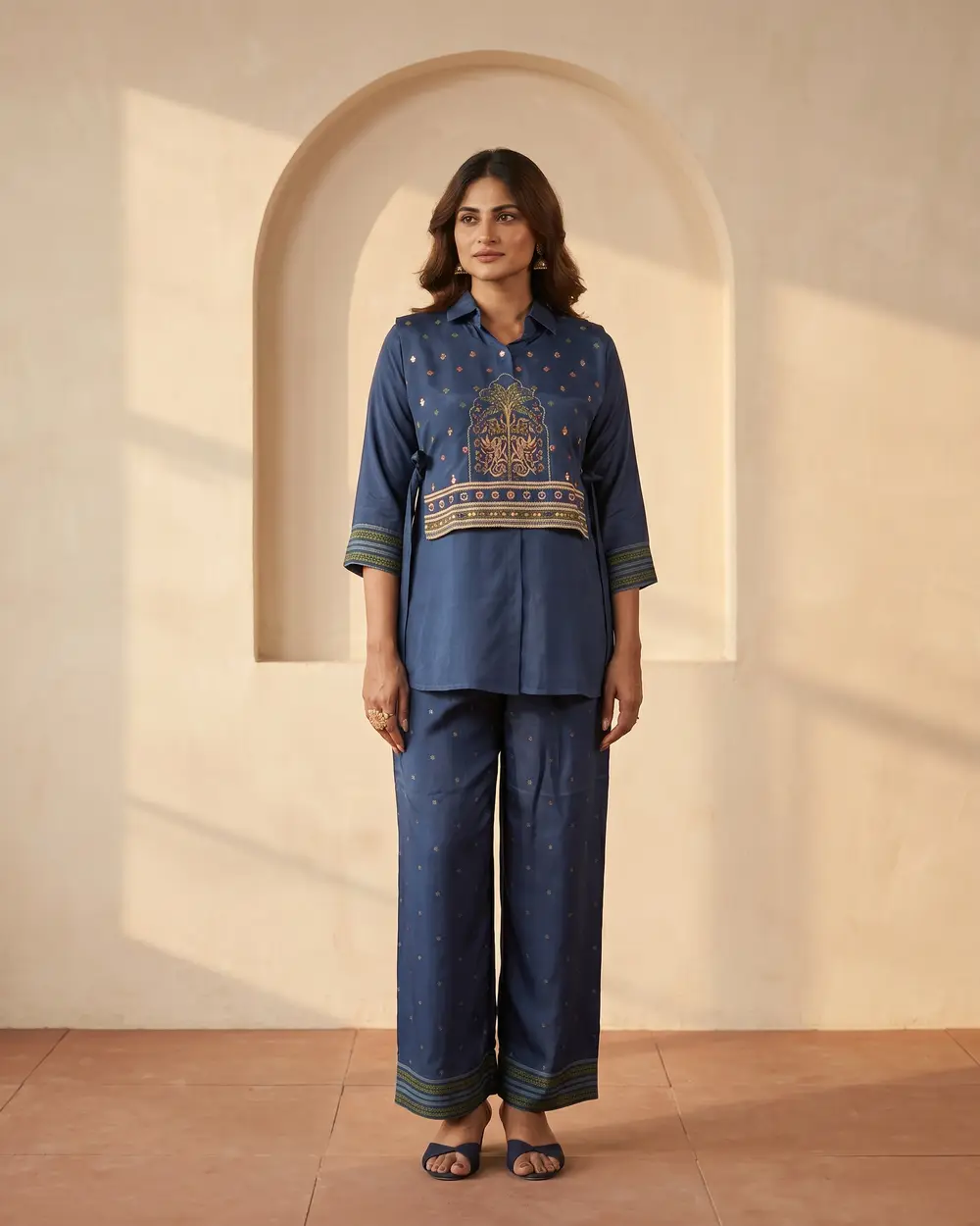 Model in a navy crepe co-ord set with gold embroidery